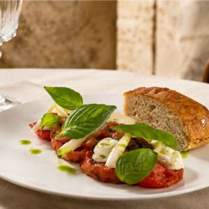 Pomodoro alla brace con ricotta di capra, cipolla marinata e olio al basilico